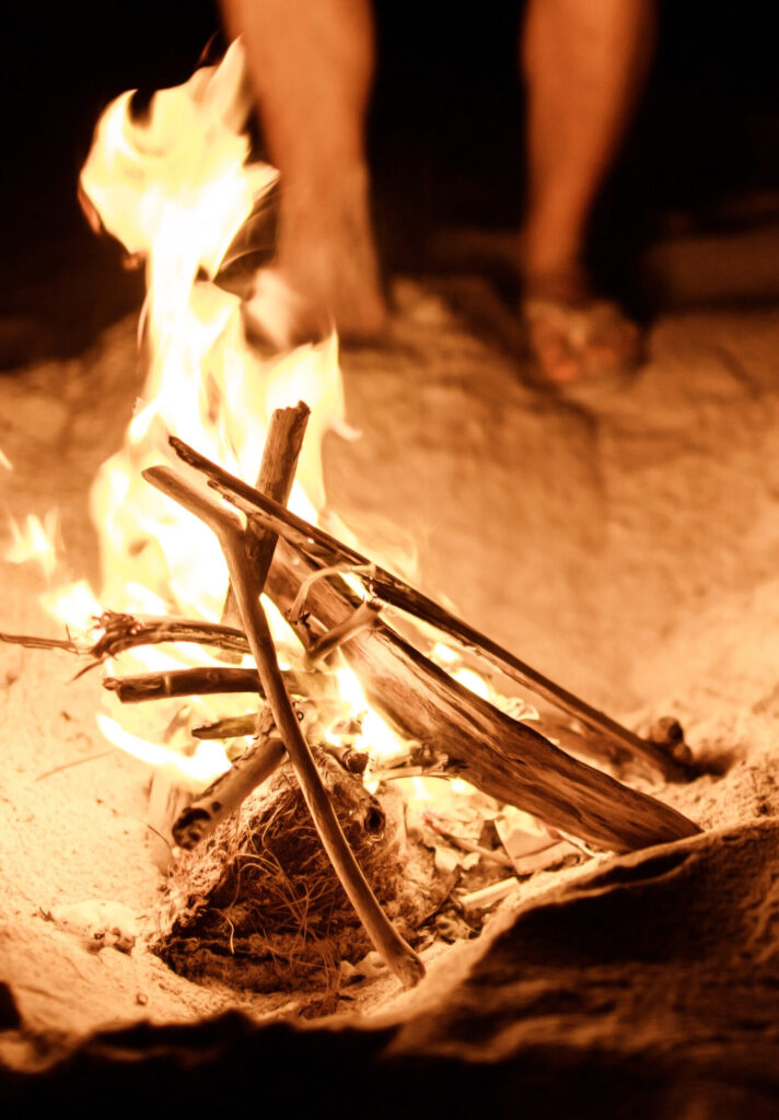 tourist makes a fire on the beach